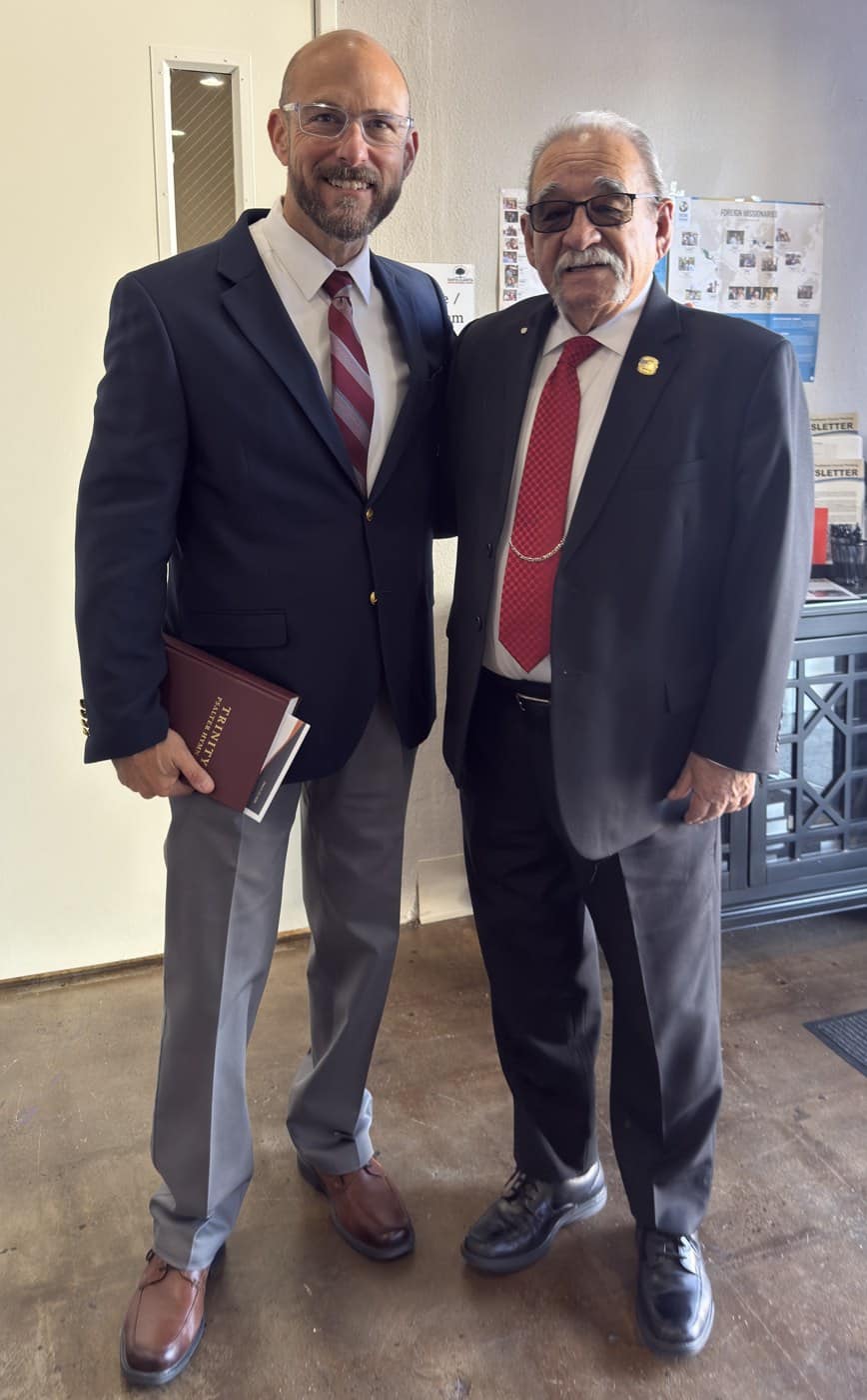 Two members greeting one another in the Santa Clarita URC foyer after worship