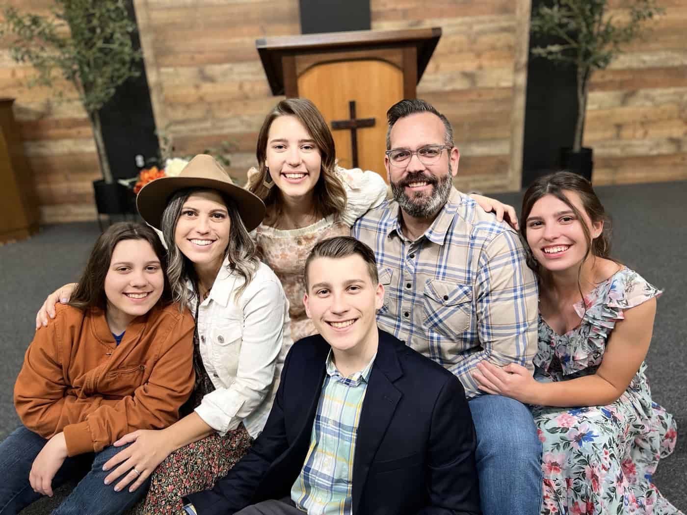 A family of Santa Clarita United Reformed Church gathered together in front of the pulpit and cross