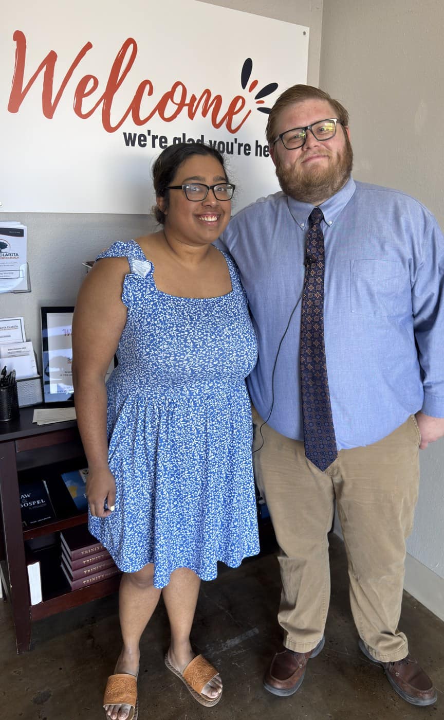 A visiting couple welcomed beneath the Welcome sign at Santa Clarita URC