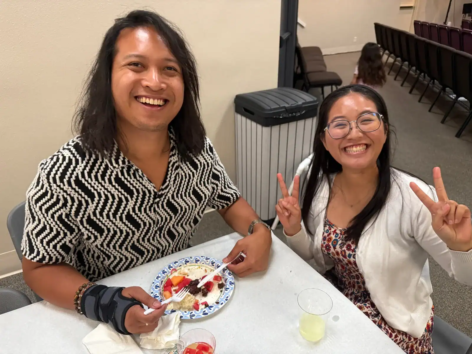 Two members smiling during fellowship after worship